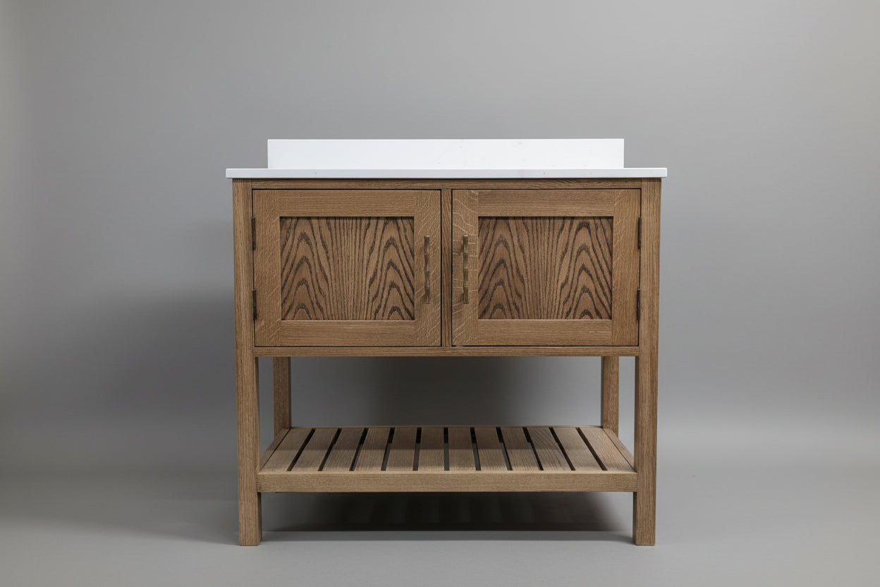 Wooden bathroom vanity with two doors and a shelf on a plain background